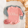 Hand-knit frill leg newborn announcement romper