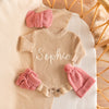 Hand-knit frill leg newborn announcement romper